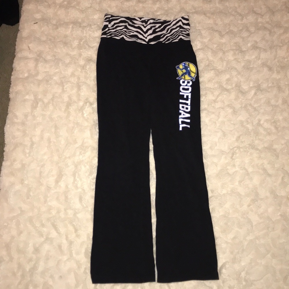 Black yoga pants with softball written on it.